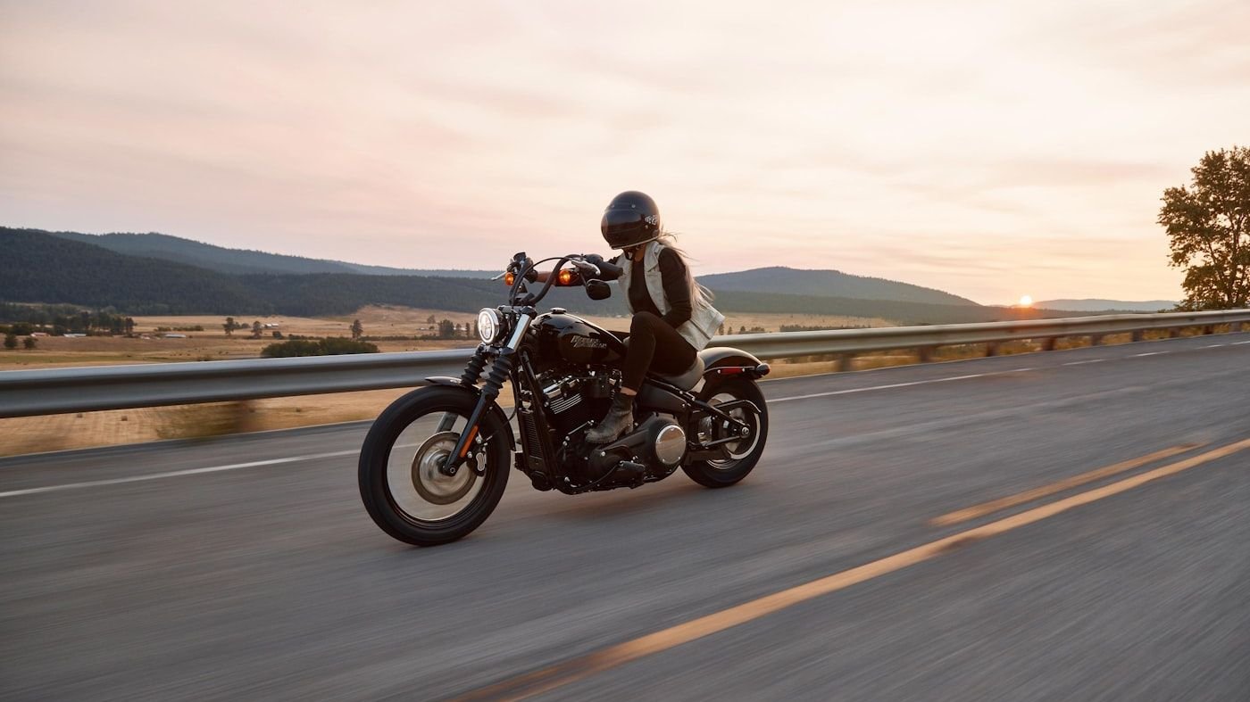 Motorcycle on an open road at sunset